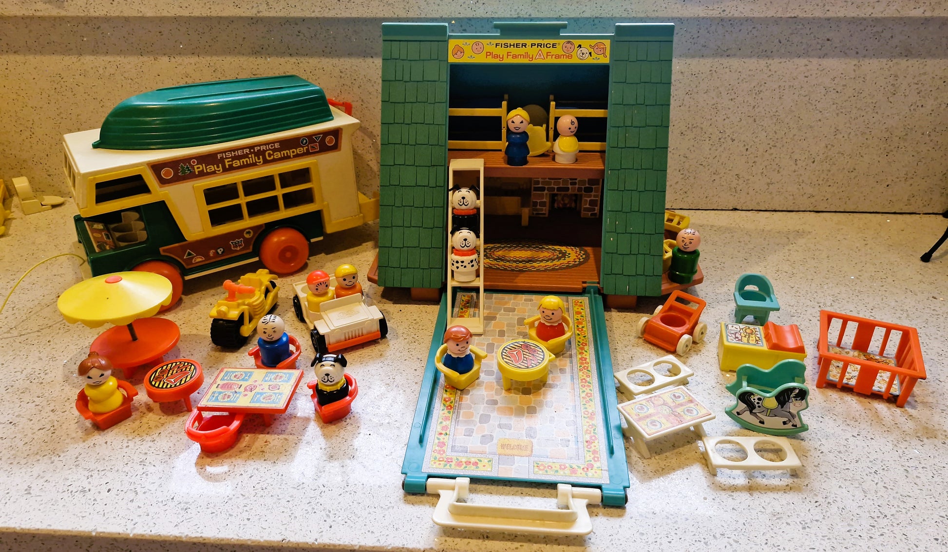 Vintage toy set with a toy store and various small figures on a textured surface.