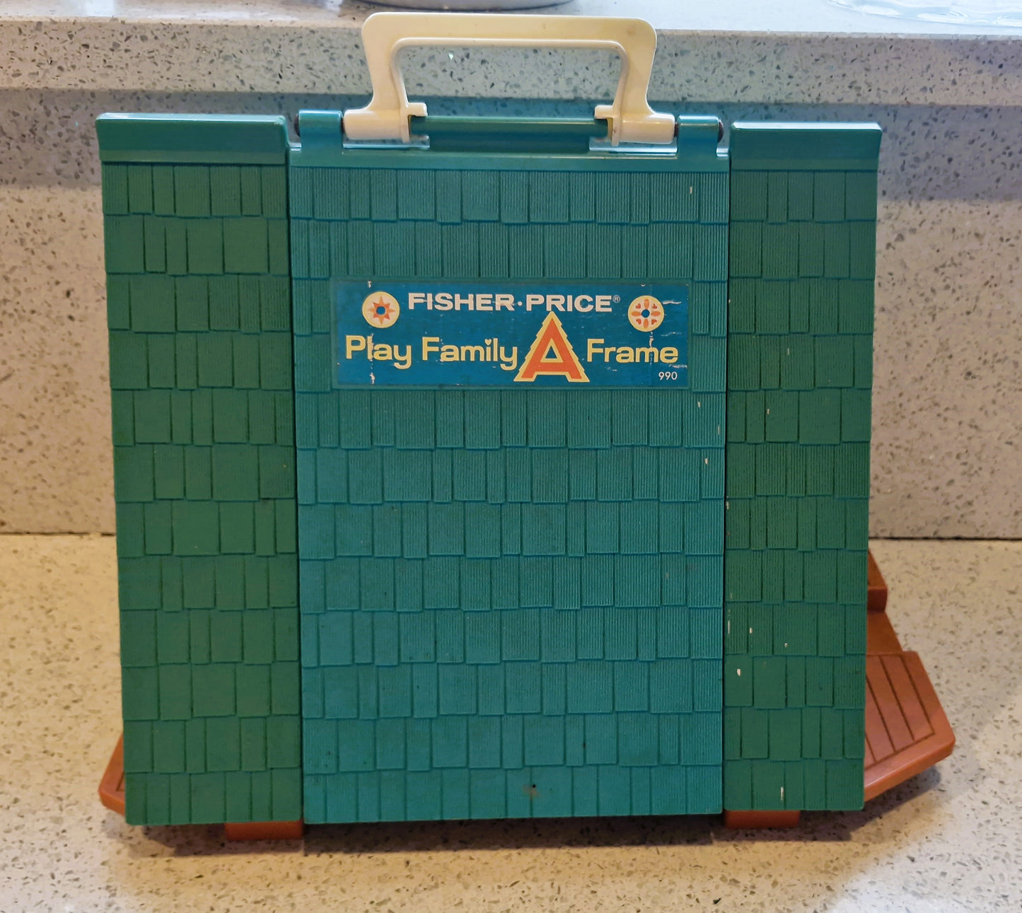 Fisher-Price Play Family A Frame toy on a countertop