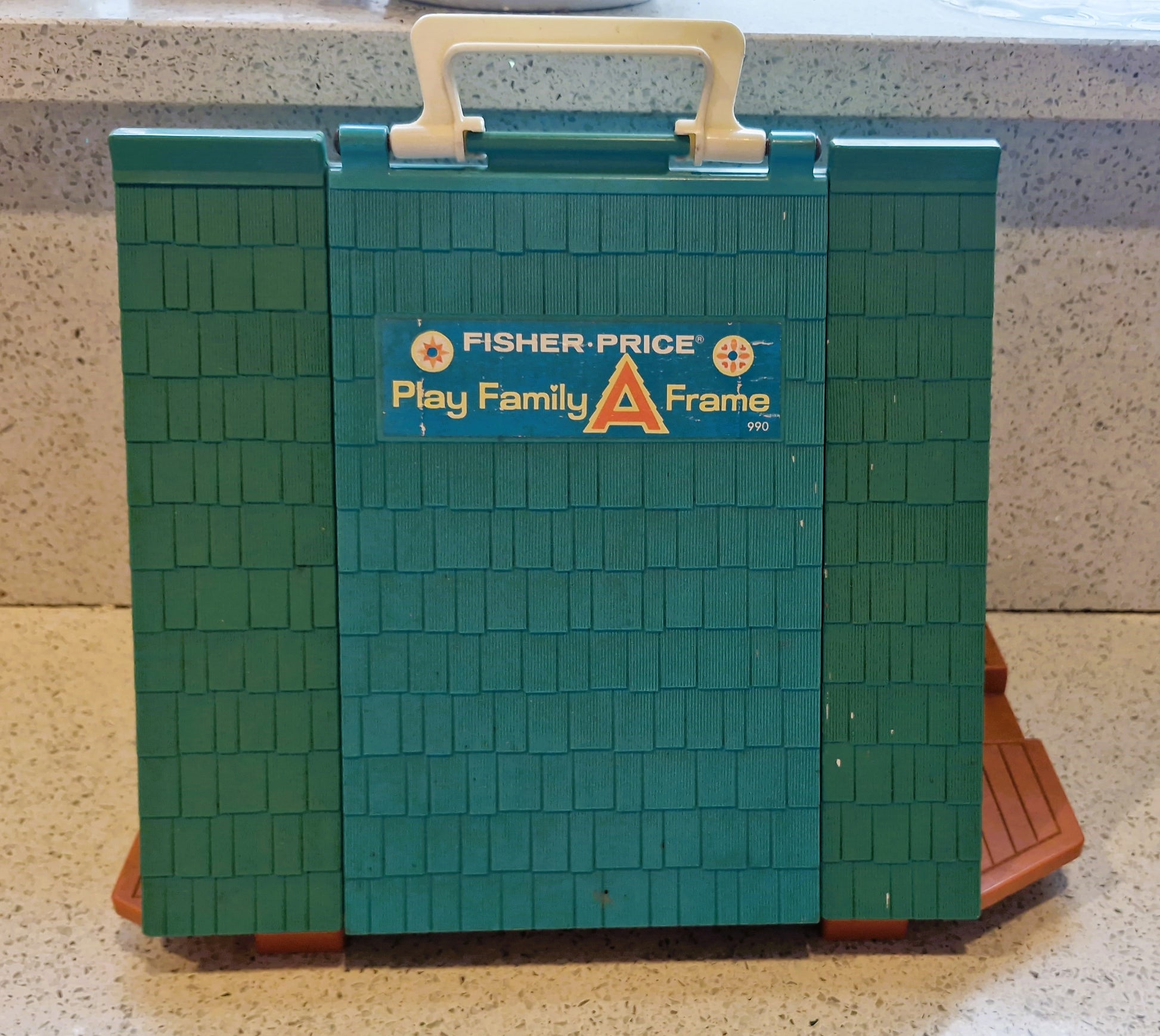 Fisher-Price Play Family A Frame toy on a countertop