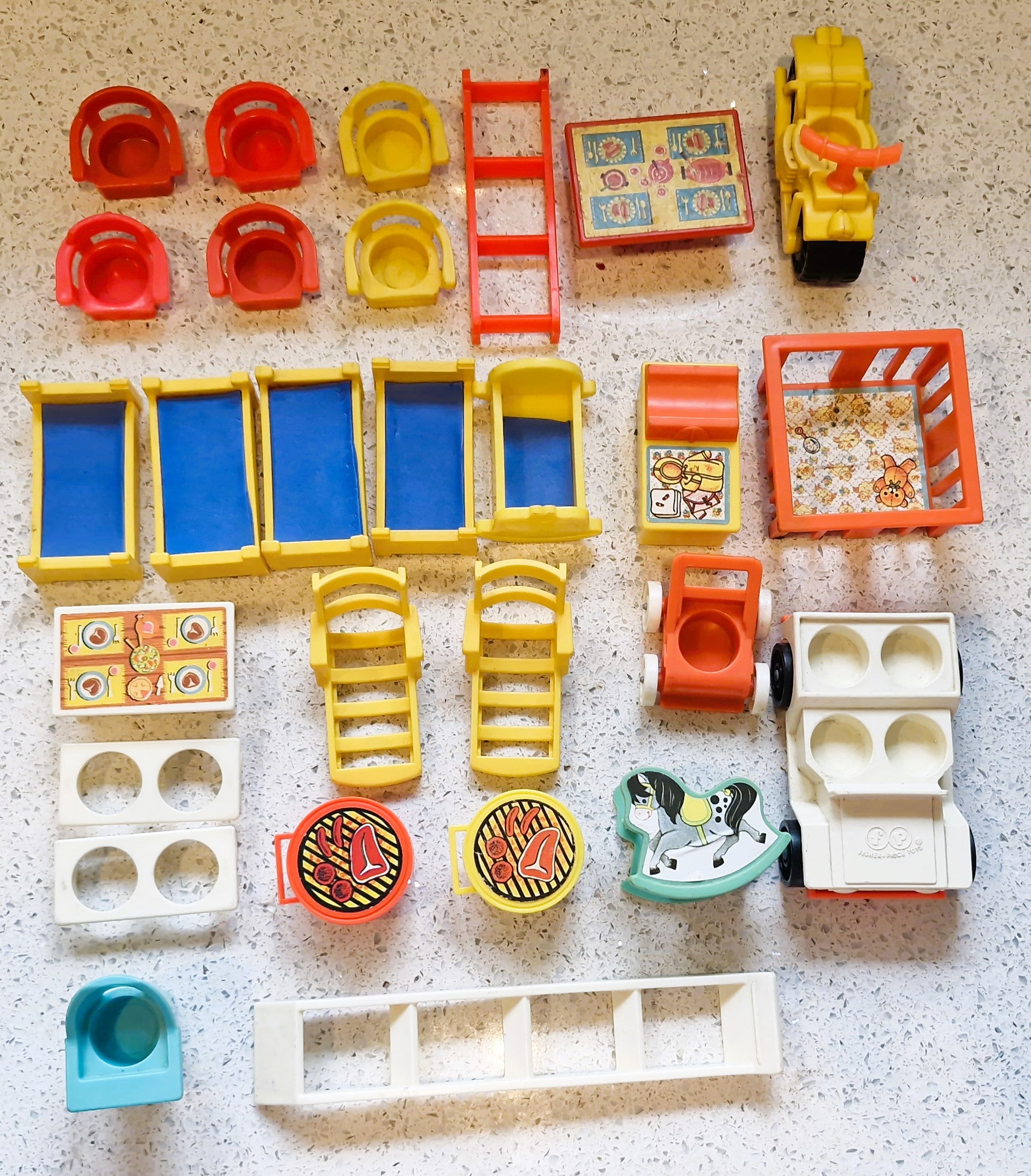 Collection of colorful toy building blocks and pieces on a textured surface